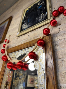 Cream ribbon garland with red ornaments