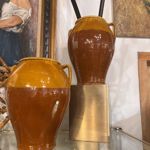 Set of two amber colored drip glazed pottery vessel flanking pair