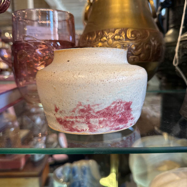 Cream pottery bowl with pink and turquoise inside