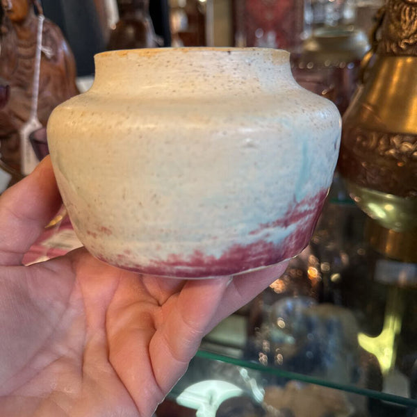 Cream pottery bowl with pink and turquoise inside