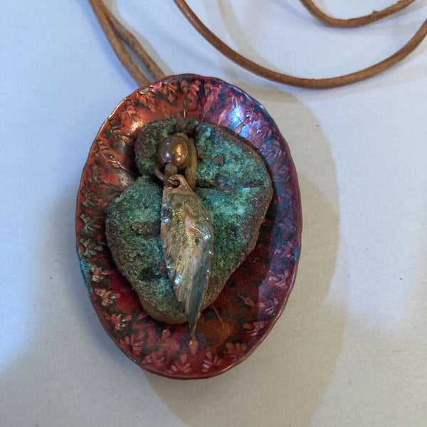 Vintage oval copper pendant with feather on leather (1.5x2.5 in)