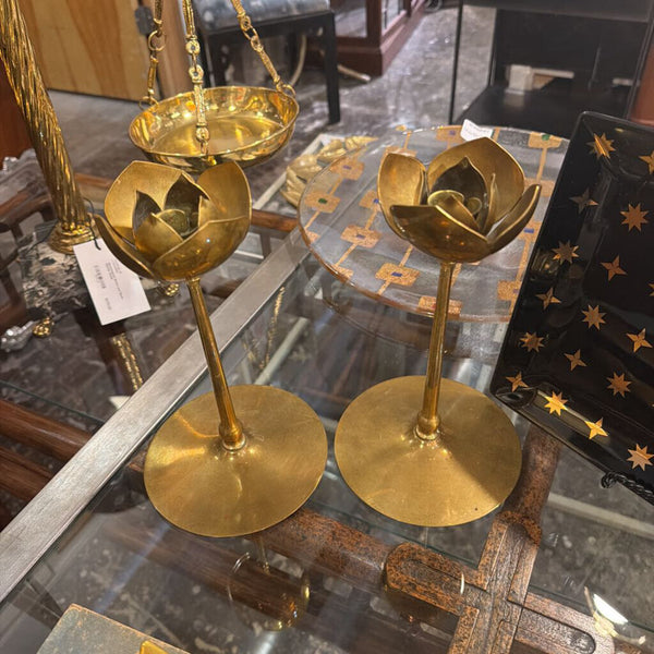 Pair of brass candle sticks with floral top