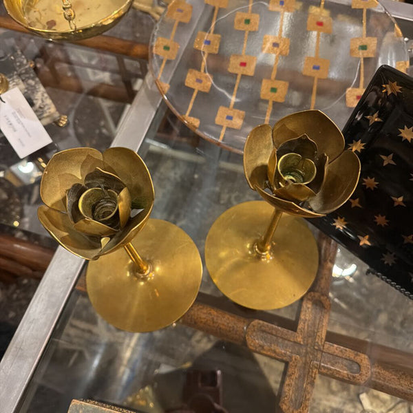 Pair of brass candle sticks with floral top
