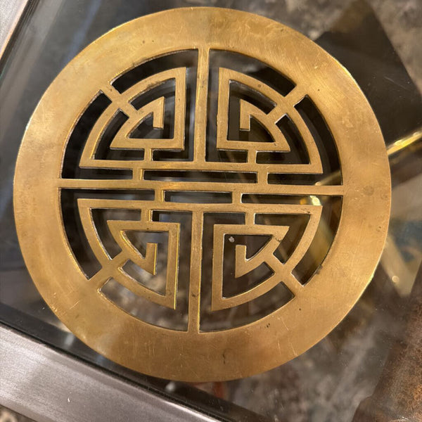 Round brass Asian trivet symbol