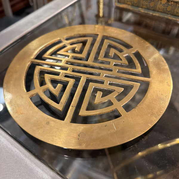Round brass Asian trivet symbol