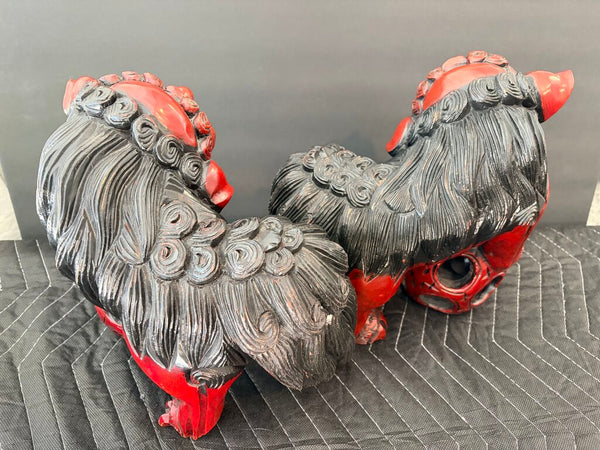Matching pair of carved food dogs with double trapped balls, approximately 10 inches tall by 12 inches long