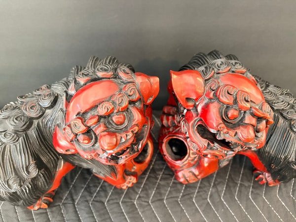 Matching pair of carved food dogs with double trapped balls, approximately 10 inches tall by 12 inches long